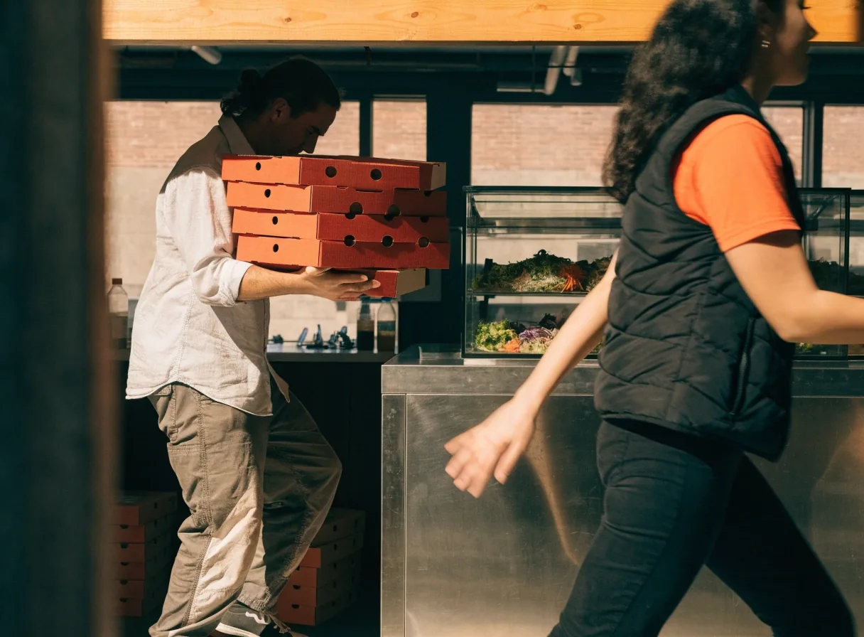 Pickup of pizza boxes and salad at a Dion's counter