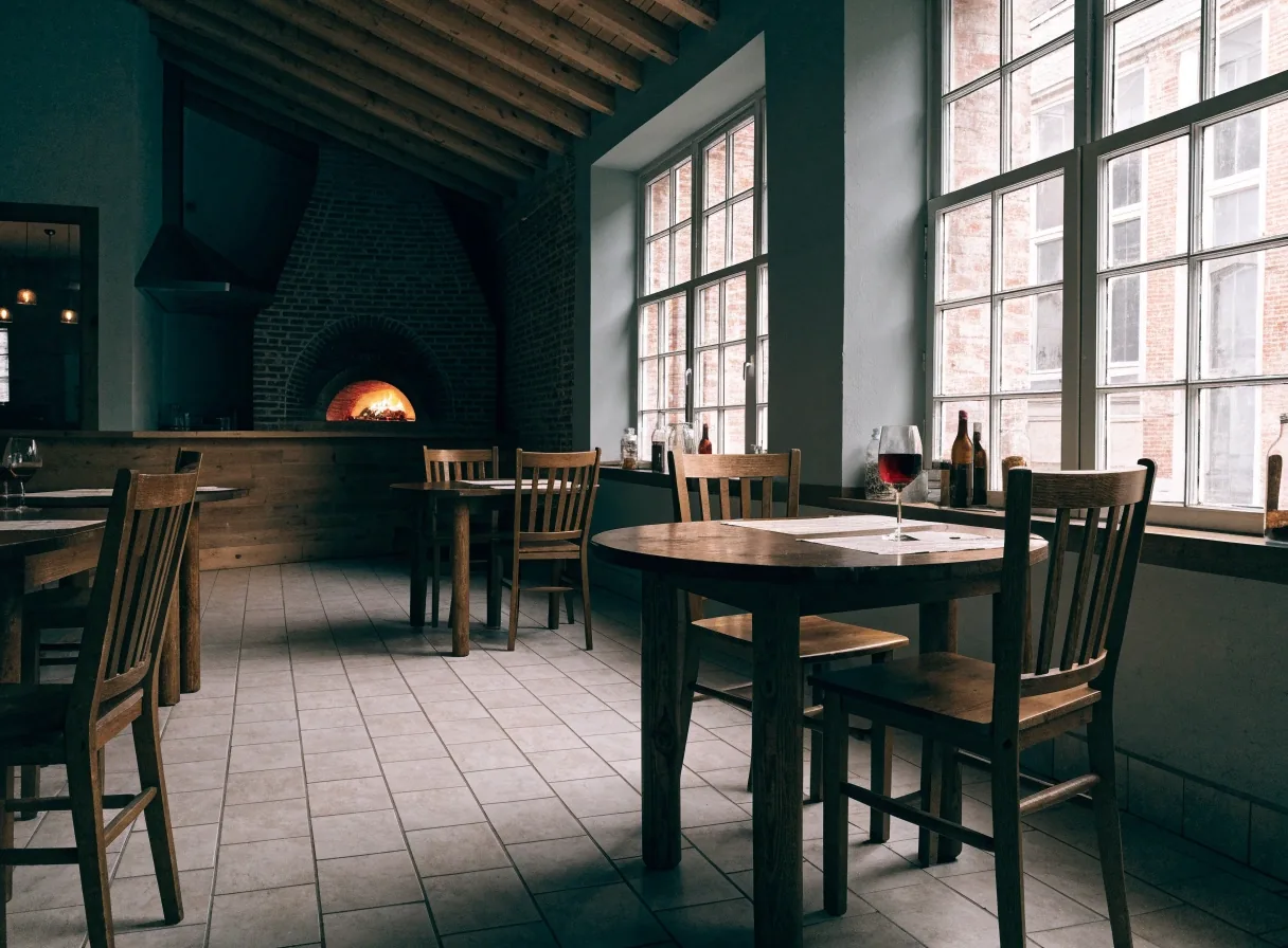 Dining room inside a Dion's Pizza restaurant with brick oven and set tables